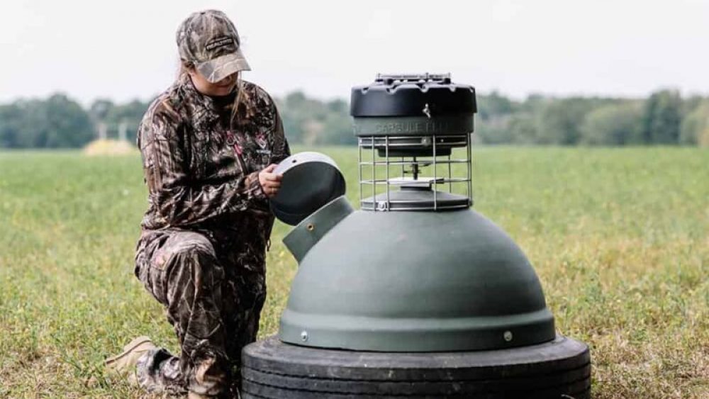 Hunter refilling a game feeder.